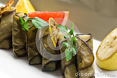 Stuffed eggplant with greens, grapefruit, lemon and banana slice Stock Photo