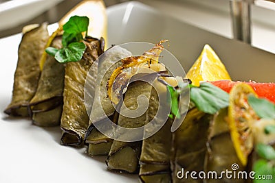 Stuffed eggplant with greens, grapefruit, lemon and banana slice Stock Photo