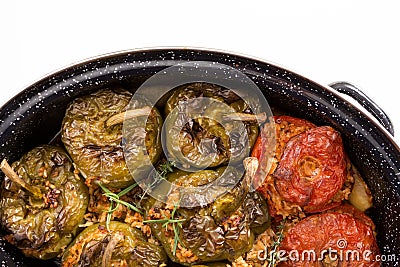 Stuffed green bell peepers and tomatoes in dish Stock Photo