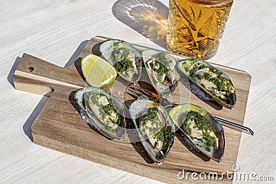 stuffed mussels on a wooden plate Stock Photo