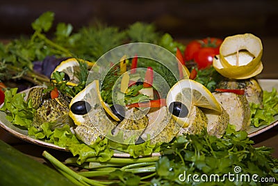 Stuffed pike with vegetables and herbs. Stock Photo