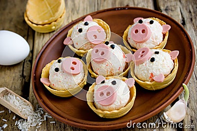 Stuffed snack tartlets with rice, crab sticks, egg, garlic Stock Photo