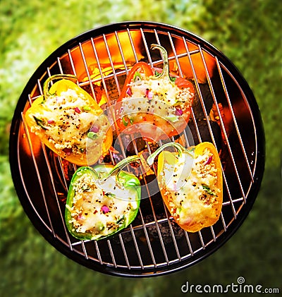 Stuffed veggy bell peppers grilling on a BBQ Stock Photo