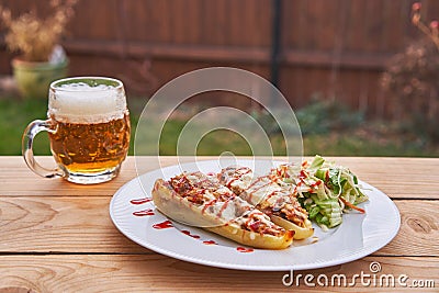 Stuffed white peppers served with pilsner beer. Stock Photo