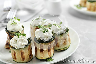 Stuffed zucchini rolls on grey marble closeup Stock Photo