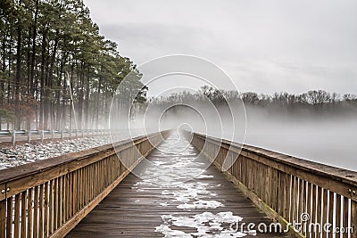 Stumpy Lake Fishing Pier in Snow, Ice and Fog Stock Photo