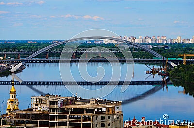 Stunning aerial landscape view of Kyiv. Podil neighborhood and River Dnipro with bridges against blue sky Editorial Stock Photo