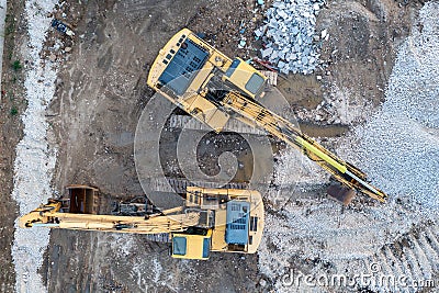 Aerial view of the stopped yellow excavators at a construction site Stock Photo