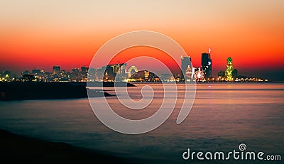 Stunning beautiful Batumi waterfront in Adjara, Georgia. Modern Architecture In Seafront Promenade In Night Or Evening Stock Photo