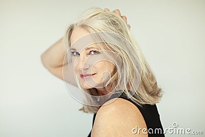 Stunning beautiful and self confident best aged woman with grey hair smiling into camera Stock Photo