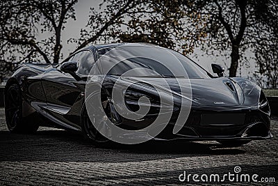 Stunning black McLaren sports car parked in an outdoor area. Editorial Stock Photo