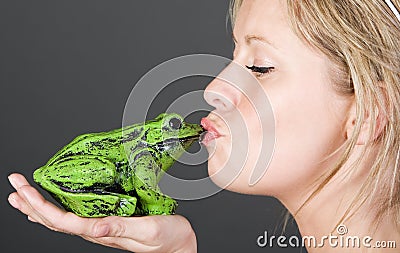 Stunning Blonde Girl Kissing a Frog Stock Photo