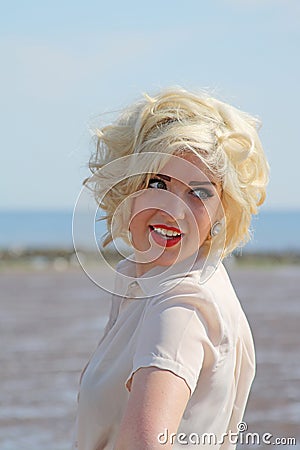 Stunning blonde haired teenage girl at the beach Stock Photo