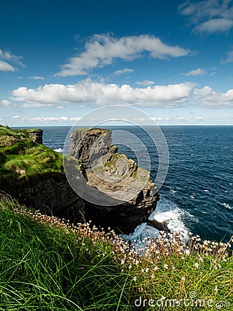 Stunning coastline of Ireland in Kilkee area. Low cloudy sky, warm sunny day. Travel, tourism and sightseeing concept. Irish Stock Photo