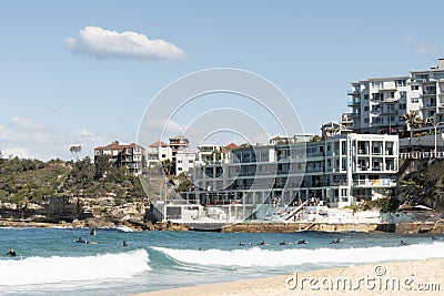 Sydney, NSW/Australia: Bondi Beach with the Iceberg Pool in the background and the surfers Editorial Stock Photo