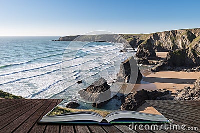 Stunning dusk sunset landscape image of Bedruthan Steps on West Cornwall coast in England coming out of pages of open story book Stock Photo