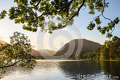 Stunning epic sunrise landscape image looking along Loweswater towards wonderful light on Grasmoor and Mellbreak mountains in Lkae Stock Photo