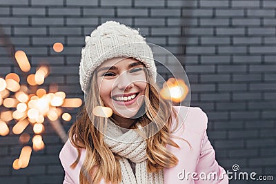 Stunning european girl in knitted accessories enjoying christmas. Outdoor shot of adorable blonde woman holding Stock Photo