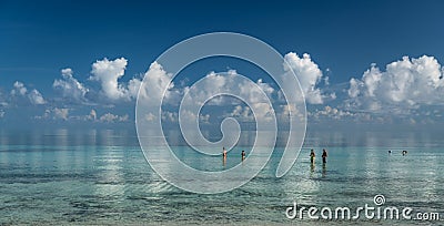 Stunning gorgeous, amazing beautiful tranquil inviting ocean view with white fluffy clouds reflected in water Editorial Stock Photo