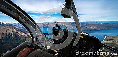 Stunning helicopter cockpit image with Wanaka lake in the background on a sunny winter day, New Zealand Editorial Stock Photo