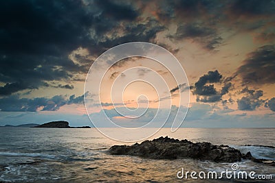 Stunning landscape dawn sunrise with rocky coastline and long ex Stock Photo