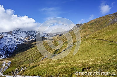 Stunning landscape of green grass Alp mountains with sun shine i Stock Photo