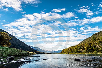 Stunning landscpae of the reflection of the snow mountain on the river. Blue sky and some cloudy. I Stock Photo