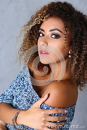 Stunning latin woman with curly hair posing in professional studio, latinoamerican woman work for model agency Stock Photo
