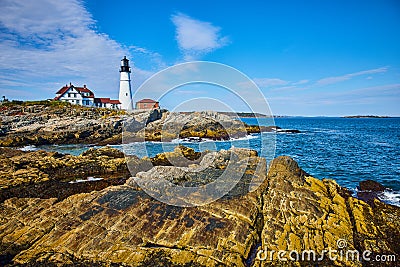 Stunning lighthouse view overlooking ocean on large rocky coastline Stock Photo