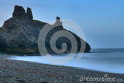 Stunning long exposure low ground close up view of seascape and Black Castle ruins South Quay Corporation Lands Co. Wicklow Stock Photo