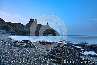 Stunning long exposure low ground evening view of seascape and Black Castle ruins South Quay Corporation Lands Co. Wicklow Stock Photo