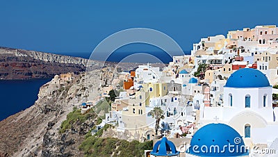 Stunning panoramic view of Santorini island with white houses and blue domes on famous Greek resort Oia, Greece, Europe. Stock Photo