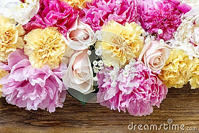 Stunning pink peonies, yellow carnations and roses Stock Photo