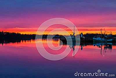 Stunning purple sunset reflection at harbour Editorial Stock Photo