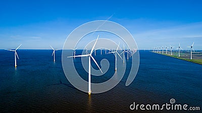 A stunning scene of countless windmills standing tall in a vast body of water in the ocean Stock Photo