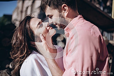 Stunning sensual outdoor portrait of young stylish fashion couple in love. Woman and man embrace and want to kiss each other Stock Photo