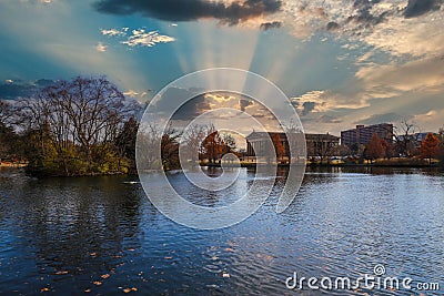 A stunning shot of the still blue lake water surrounded by gorgeous autumn trees in the park with a view of The Parthenon Stock Photo