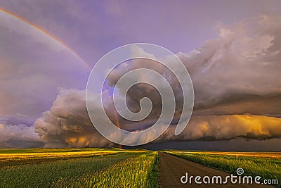 Stunning stormy sunset with rainbow Stock Photo