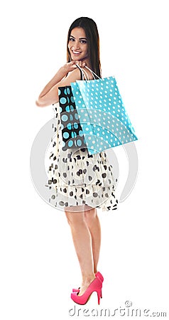 Stunning teenager carrying shopping bags Stock Photo