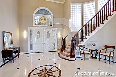 Stunning two story entry foyer with marble mosaic tiled floor Stock Photo