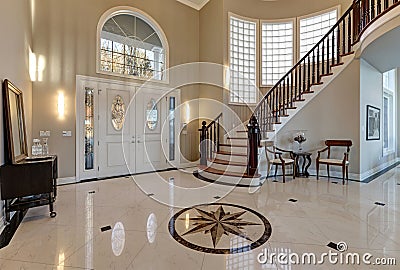 Stunning two story entry foyer with marble mosaic tiled floor Stock Photo