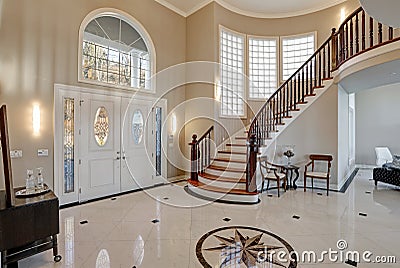 Stunning two story entry foyer with marble mosaic tiled floor Stock Photo