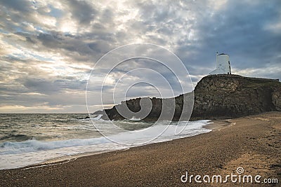 Stunning Twr Mawr lighthouse landscape from beach with dramatic Stock Photo