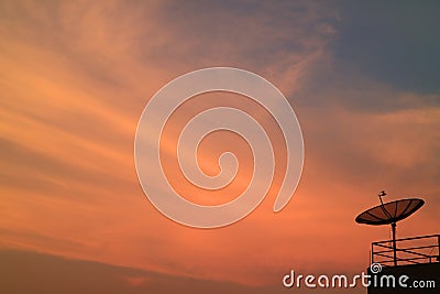 Stunning Vibrant Color of Sunset Afterglow with the Silhouette of Satellite Dish Stock Photo