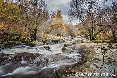 Stunning vibrant landscape image of Aira Force Upper Falls in Lake District during colorful Autumn showing Stock Photo