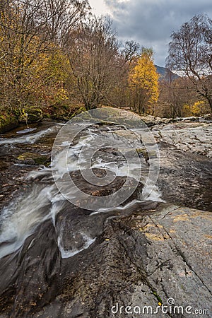 Stunning vibrant landscape image of Aira Force Upper Falls in Lake District during colorful Autumn showing Stock Photo