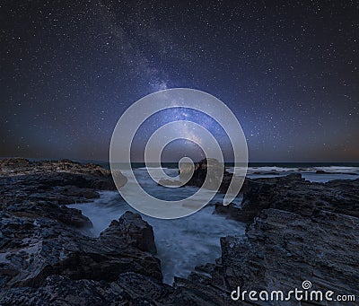 Vibrant Milky Way composite image over landscape of Cornwall coastline in England Stock Photo