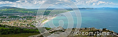 Stunning view of Bray bay from cross top mountains. Cloudy sky, blue weather and green grass Stock Photo