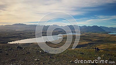 A stunning view of milky-turquoise blue Lake Tekapo from the summit of Mount John in New Zealand during autumn. Stock Photo