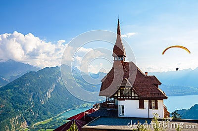 Stunning view of the top of Harder Kulm in Interlaken, Switzerland photographed in summer with paragliders flying around. Hilly Stock Photo